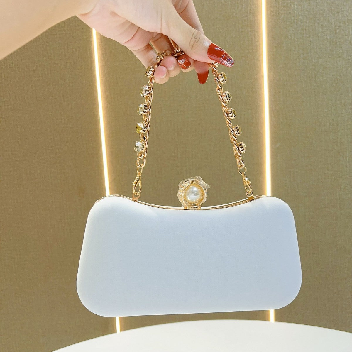 A Champagne Golden Evening Bag with an Arc Shape, Adorned with Rhinestones, Can Be Held by Hand Or Worn Cross-Body, Perfect for Formal Events